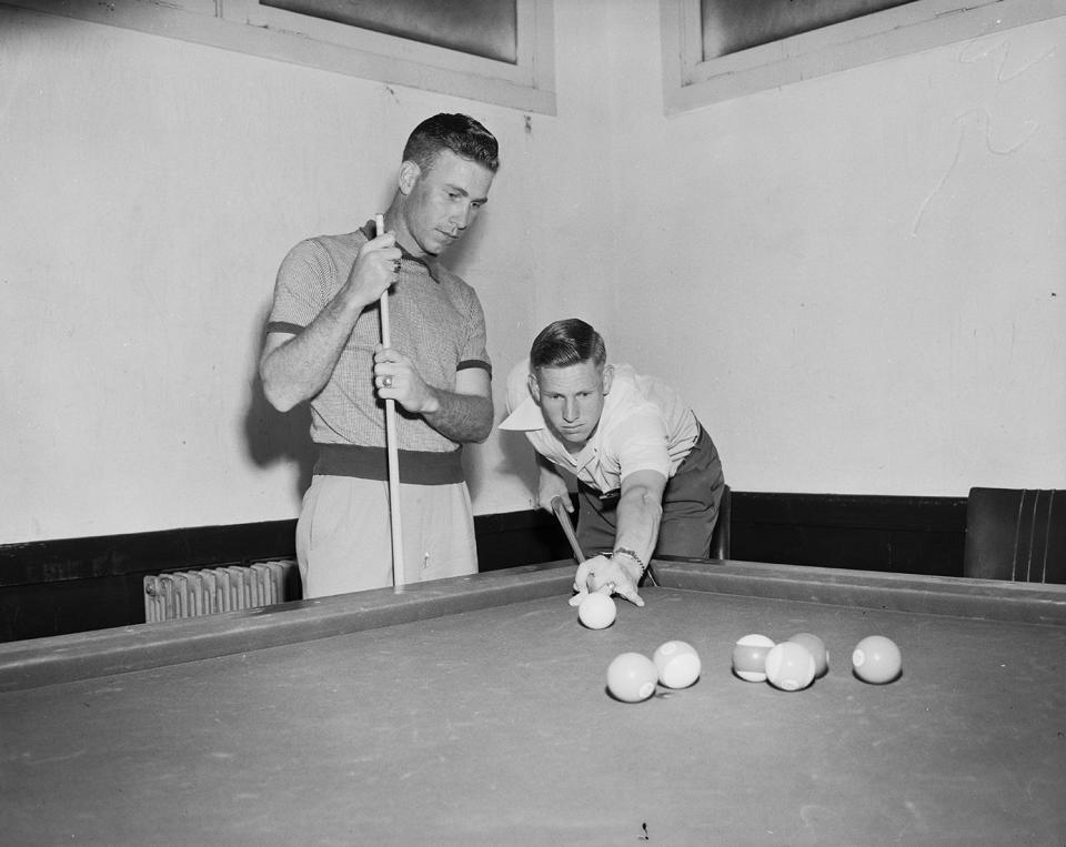 Fort Worth Cats' Jack Lindsey watches Russ Rose line up billiards shot at Dodgers' Vero Beach training camp in 1950. Rose, infielder on Montreal roster, has been playing with Cats. Lindsey is in his third year on club. Lindsey played shortstop for the Montreal Royals in the first game the Brookyln Dodgers played in Vero Beach March 31, 1948.