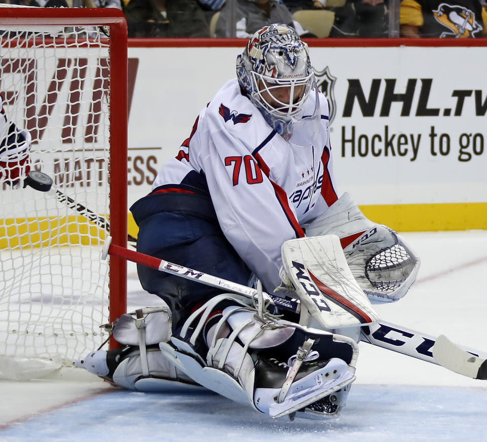 Washington Capitals goaltender Braden Holtby deflects a shot during the second period of the team's NHL hockey game against the Pittsburgh Penguins in Pittsburgh, Thursday, Oct. 4, 2018. (AP Photo/Gene J. Puskar)