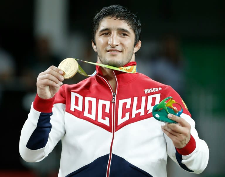 Russia's gold medallist Abdulrashid Sadulaev celebrates on the podium at the end of the men's 86kg freestyle wrestling event in Rio de Janeiro on August 20, 2016 (Jack Guez)