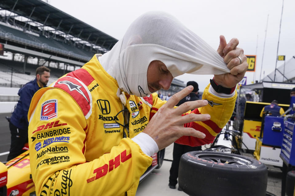 Romain Grosjean, of France, pull off his balaclava during IndyCar auto racing testing at Indianapolis Motor Speedway, Wednesday, April 20, 2022, in Indianapolis. (AP Photo/Darron Cummings)