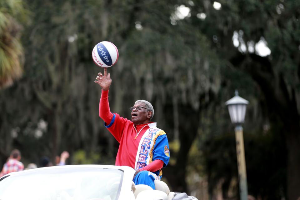 Larry "Gator" Rivers, a member of the Chatham County Commission and a former Harlem Globetrotter, shows off his ball handling skills as he rides in the annual Savannah Veterans Day Parade.