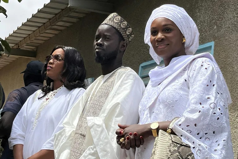 Senegal's president-elect Bassirou Diomaye Faye (C) with his wives Marie Khone Faye (L) and Absa Faye (R) (Khadidiatou Sene)