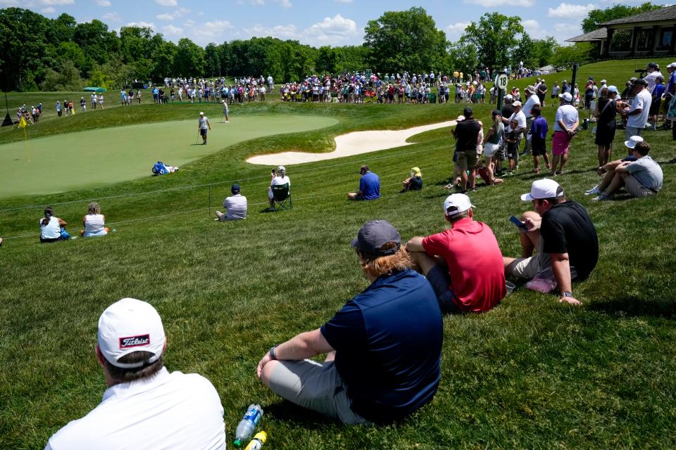 May 30, 2023; Dublin, Ohio, USA;  Spectators watch Rory McIlroy putt on the 18th hole during a practice round for the Memorial Tournament at Muirfield Village Golf Club in Dublin. 