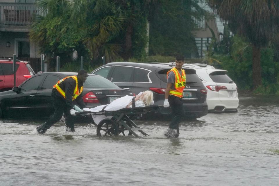 Authorities transport a person out of the Avante nursing home in the aftermath of Hurricane Ian, Thursday, Sept. 29, 2022, in Orlando, Fla. Hurricane Ian carved a path of destruction across Florida, trapping people in flooded homes, cutting off the only bridge to a barrier island, destroying a historic waterfront pier and knocking out power to 2.5 million people as it dumped rain over a huge area on Thursday.