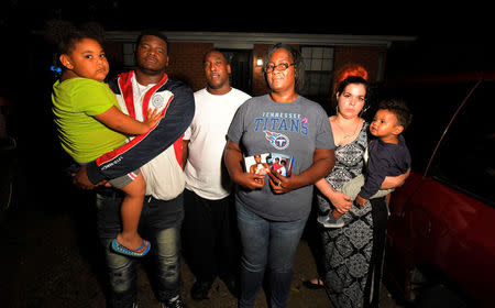 Quinta Sanders (C) poses in front of her of home with members of her family, Ta'Heirra Sanders, granddaughter, Edward Sanders, son, Terrence Sanders, son, and Summer Barrett, wife of Tory, and Denver Sanders, grandson (L-R), while speaking about the death of her son Tory with Reuters in Nashville, Tennessee, U.S. October 10, 2017. Picture taken October 10, 2017. REUTERS/Harrison McClary