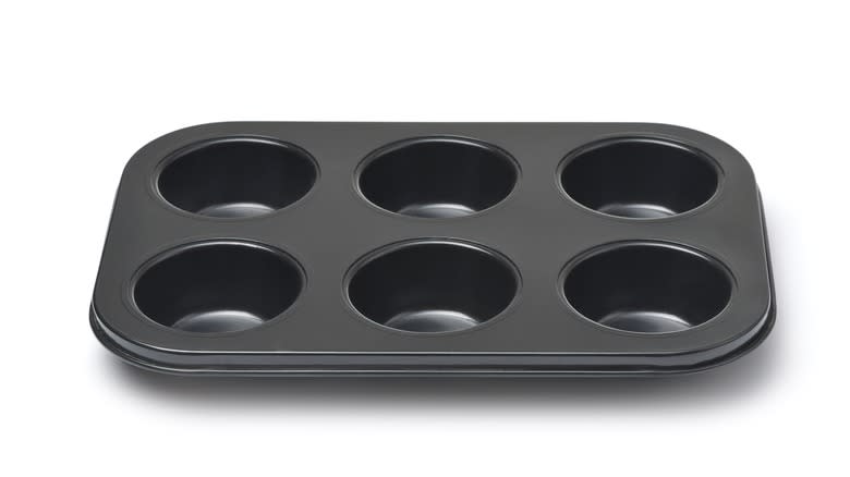 Empty muffin tin white background