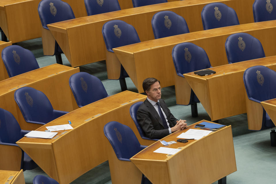 FILE - In this file photo dated Thursday, April 1, 2021, Dutch caretaker Prime Minister Mark Rutte listens to a debate in parliament in The Hague, Netherlands. Rutte announced a significant easing in his country's months-long coronavirus lockdown Tuesday April 20, 2021, calling it a delicate balancing act as infections remain stubbornly high, and as lockdown fatigue grows.(AP Photo/Peter Dejong)