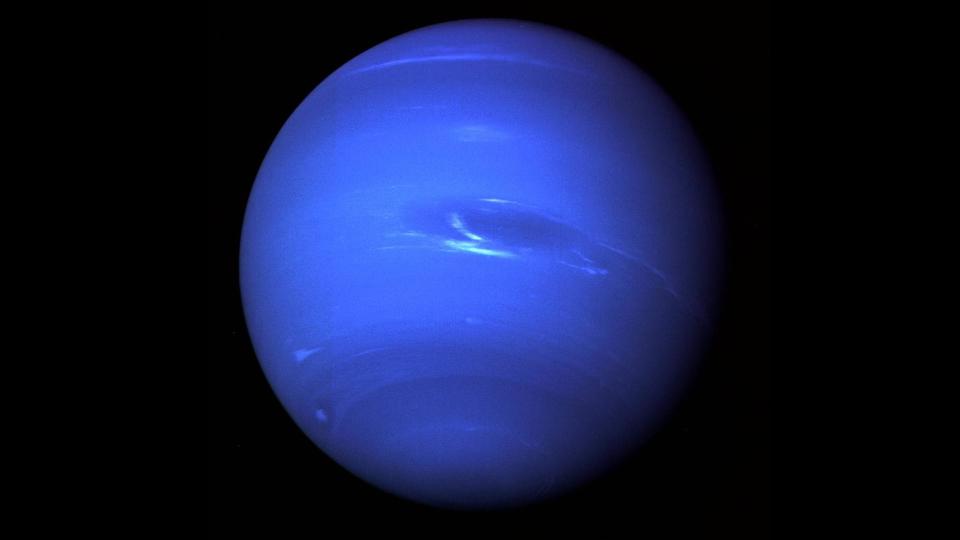 a blue planet streaked with bands of lighter and dark blues