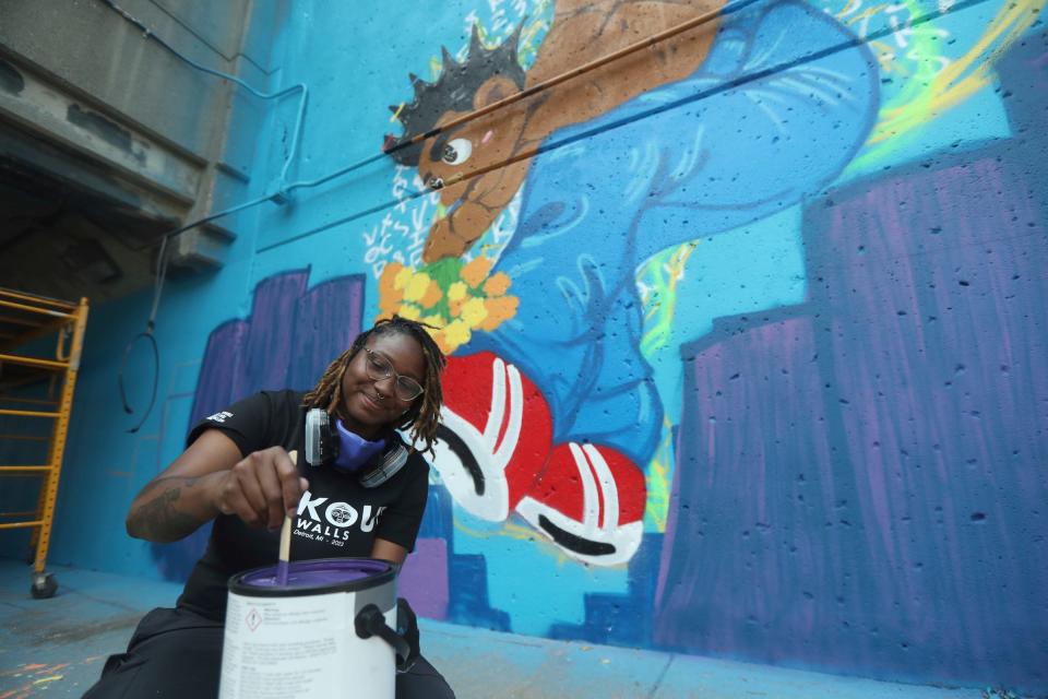 The BLKOUT Mural Festival hosted local and national artists along with some from the International scene to work on 25 murals around metro Detroit Monday, September 11, 2023. Tiera Knaff from Detroit works on her mural Give People Their Flowers along Woodward Ave.