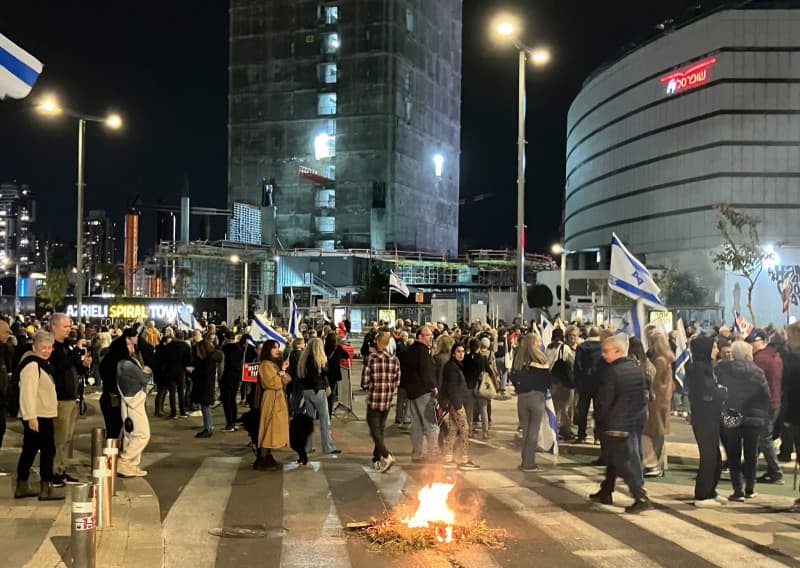 Relatives and supporters of Israeli hostages held by the Islamist Hamas in the Gaza Strip block a road and set fire to the street during a rally calling for the release of hostages held by the Islamist Hamas and against Prime Minister Netanyahu's government. Cindy Riechau/dpa