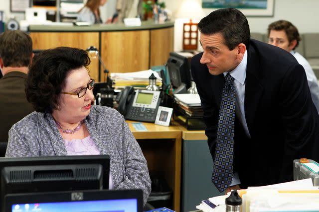 <p>Chris Haston/NBC/NBCU Photo Bank/Getty</p> Phillis Smith as Phyllis Lapin and Steve Carell as Michael Scott in "The Office" in 2011