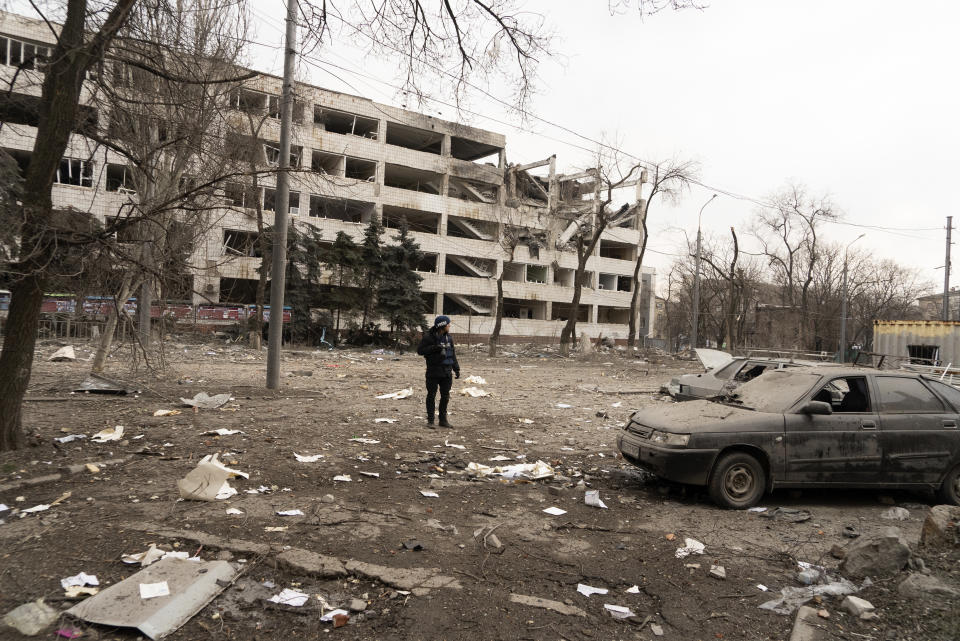 FILE - Associated Press photographer Evgeniy Maloletka stands amid rubble of an airstrike on Pryazovskyi State Technical University on March 10, 2022, in Mariupol, Ukraine. Maloletka and Mstyslav Chernov, two Ukrainians who documented the horrors of the Russian invasion and siege of Mariupol for The Associated Press, are being honored for their courage with Colby College's Lovejoy Award. (AP Photo/Mstyslav Chernov, File)