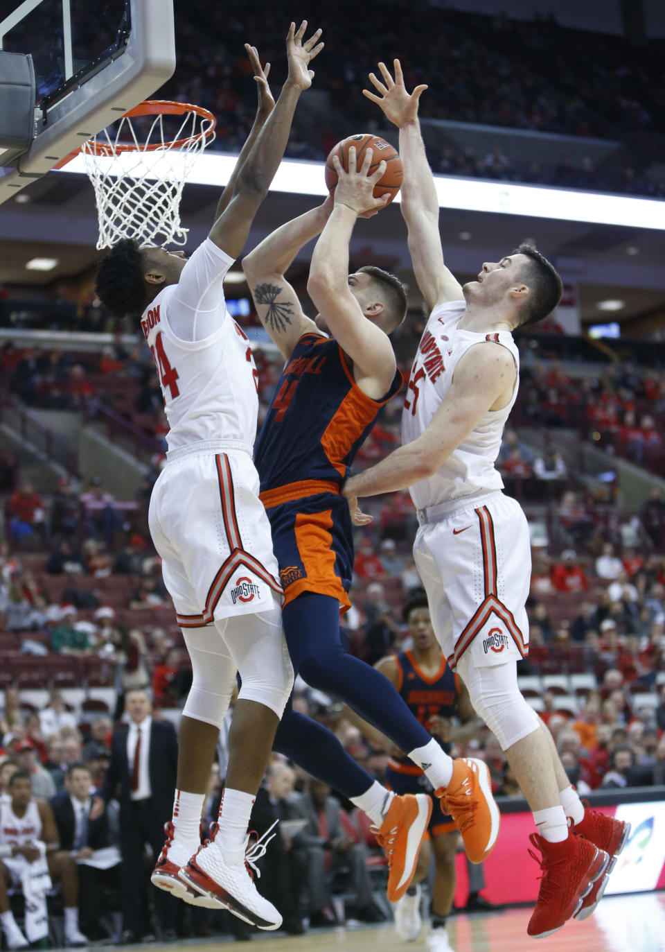 Bucknell's Nate Sestina, center, shoots between Ohio State's Andre Wesson, left, and Kyle Young,right, during the first half of an NCAA college basketball game Saturday, Dec. 15, 2018, in Columbus, Ohio. (AP Photo/Jay LaPrete)