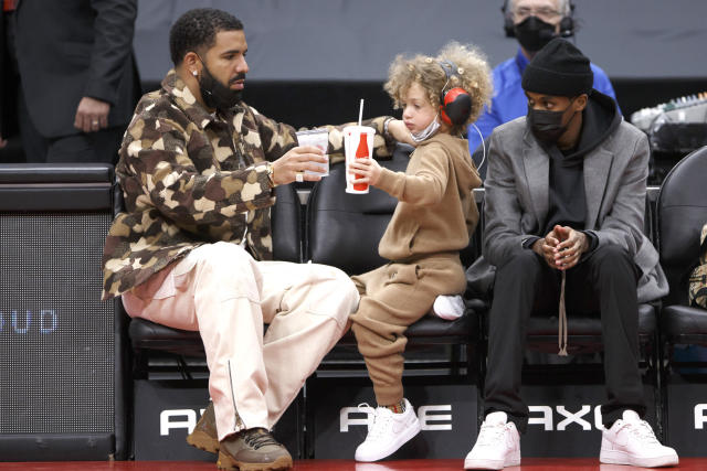 Drake and his son Adonis pose in matching outfits at mum's birthday party