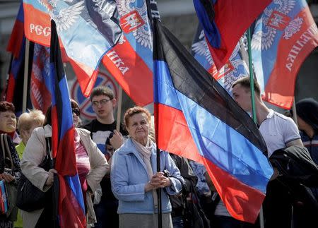 People carry flags of the self-proclaimed Donetsk People's Republic as they attend a rally dedicated to the second anniversary of the republic's founding in Donetsk, Ukraine, April 9, 2016. REUTERS/Alexander Ermochenko/File Photo