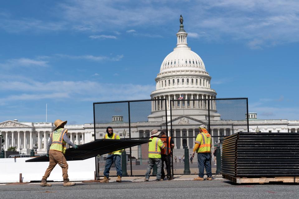 July 10, 2021: Workers remove the fence surrounding the U.S. Capitol building, six months after it was erected following the Jan. 6 riot at the Capitol in Washington.
