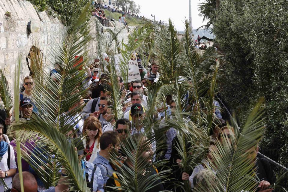 Catholic faithful hold palm fronds during a Palm Sunday procession in Jerusalem