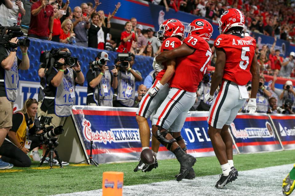 Sep 3, 2022; Atlanta, Georgia, USA; Georgia Bulldogs wide receiver Ladd McConkey (84) celebrates after a touchdown with offensive lineman Xavier Truss (73) and wide receiver Adonai Mitchell (5) against the Oregon Ducks in the first quarter at Mercedes-Benz Stadium. Brett Davis-USA TODAY Sports