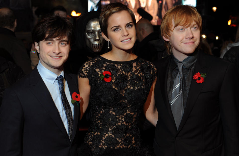 Daniel Radcliffe (L), Emma Watson, (C) and Rupert Grint pose for photographers as they arrive to attend the World Premiere of 'Harry Potter And The Deathly Hallows: Part One' in Leicester Square, central London on November 11, 2010.
