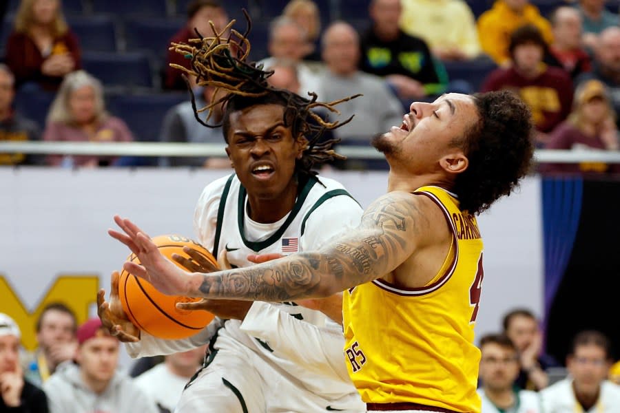 MINNEAPOLIS, MINNESOTA – MARCH 14: Coen Carr #55 of the Michigan State Spartans commits an offensive foul against Braeden Carrington #4 of the Minnesota Golden Gophers in the first half in the Second Round of the Big Ten Tournament at Target Center on March 14, 2024 in Minneapolis, Minnesota. (Photo by David Berding/Getty Images)