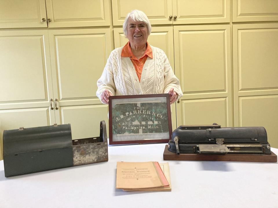 Museum curator Jane French displays a Parker stencil, a slide-out lunch box, annual town reports dating from the 1800s, and an 1896 check writer during her recent "Museum Surprises" presentation in Phillipston.