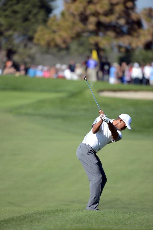 Tiger Woods plays his third shot on the 11th hole of the north course during the first round of the Farmers Insurance Open on February 5, 2015 in La Jolla, California