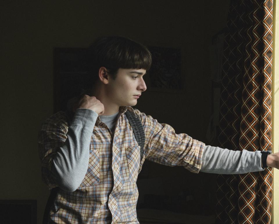 Will standing pensively by a window