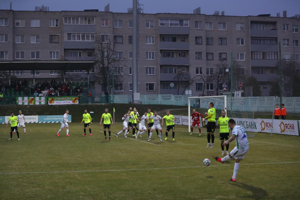 FILE In this photo taken on Saturday, March 28, 2020, Gorodeya's Milan Joksimovic, right back to camera, kicks the ball during the Belarus Championship soccer match between Gorodeya and Shakhter in the town of Gorodeya, Belarus. Longtime Belarus President Alexander Lukashenko refused to impose any restrictions, making Belarus the only country in Europe to continue playing professional soccer games with fans in the stands while the outbreak was in full swing. (AP Photo/Sergei Grits, File)