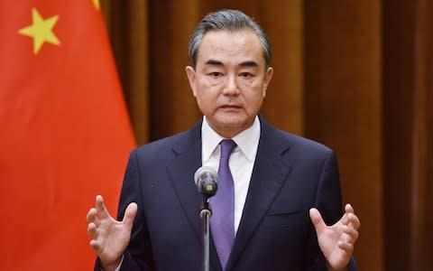 Chinese Foreign Minister Wang Yi speaks about the summit between US President Donald Trump and North Korean leader Kim Jong Un, during a joint briefing with Association of South East Asian Nations (ASEAN) Secretary-General Lim Jock Hoi at the Foreign Ministry in Beijing - Credit: Getty/Pool