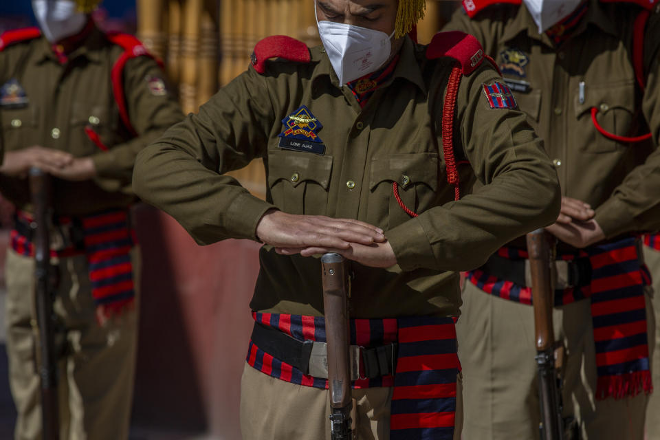 Indian police officers pay respect to their colleague Rameez Ahmad during a wreath laying ceremony in Srinagar, Indian controlled Kashmir, Thursday, April 1, 2021. Gunmen in disputed Kashmir on Thursday killed a policeman as they tried to storm the residence of a politician of India's ruling party, police said. (AP Photo/ Dar Yasin)