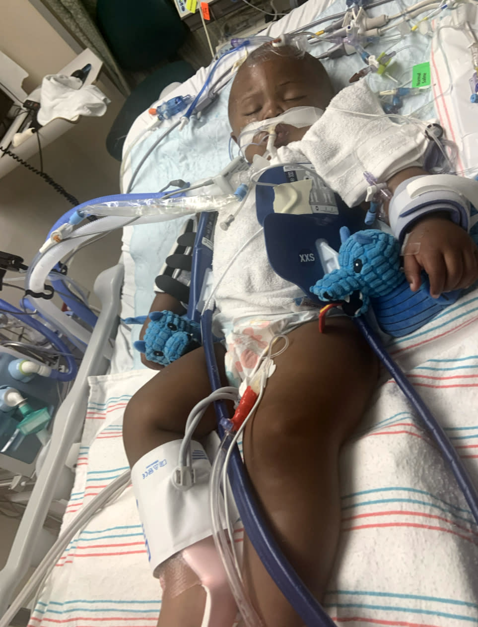 Image: Legend Smalls lies in a hospital bed in critical condition (Courtesy Attorney for family / Courtesy Attorney for Family)
