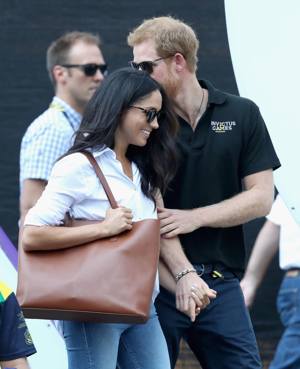 Harry kept a protective hand on Meghan's arm. Source: Getty