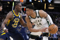 Milwaukee Bucks forward Giannis Antetokounmpo (34) drives on Indiana Pacers forward Aaron Nesmith (23) during the second half of an NBA basketball game in Indianapolis, Wednesday, March 29, 2023. (AP Photo/Michael Conroy)