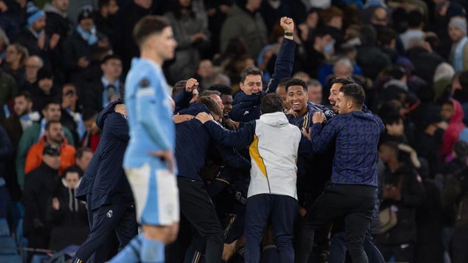 Real Madrid players celebrate with Julian Alvarez in the foreground