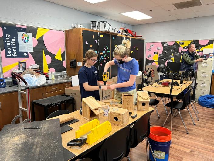 Two students work together on a birdhouse project during a course called Experiential Learner Mastermind that allows students freedom over their education.