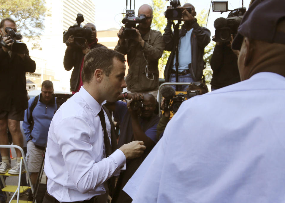 Oscar Pistorius arrives at the high court in Pretoria, South Africa, Friday, April 11, 2014. The chief prosecutor laughed scornfully at an answer from Pistorius during the Olympic athlete's murder trial Thursday, mocking the man who shot his girlfriend. Pistorius is charged with murder for the shooting death of his girlfriend, Reeva Steenkamp, on Valentines Day in 2013. (AP Photo/Themba Hadebe)