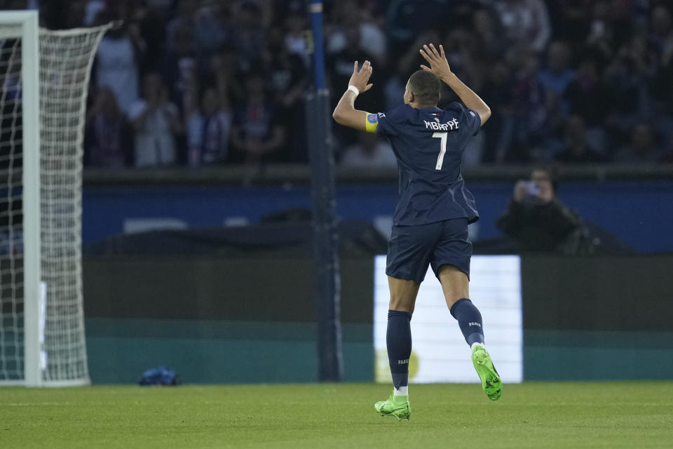 PSG's Kylian Mbappe celebrates after scoring his side's opening goal during the French League One soccer match between Paris Saint-Germain and Toulouse at the Parc des Princes stadium in Paris, Sunday, May 12, 2024. (AP Photo/Christophe Ena)