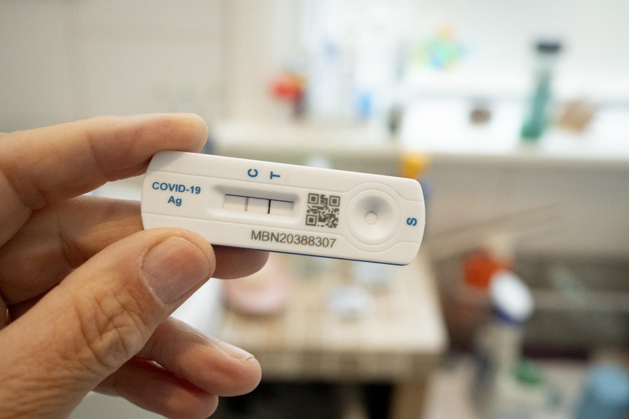 A detail of a hand holding a Covid lateral flow test that shows a positive result in a bathroom, 13th July 2024, in London, England. (Photo by Richard Baker / In Pictures via Getty Images)