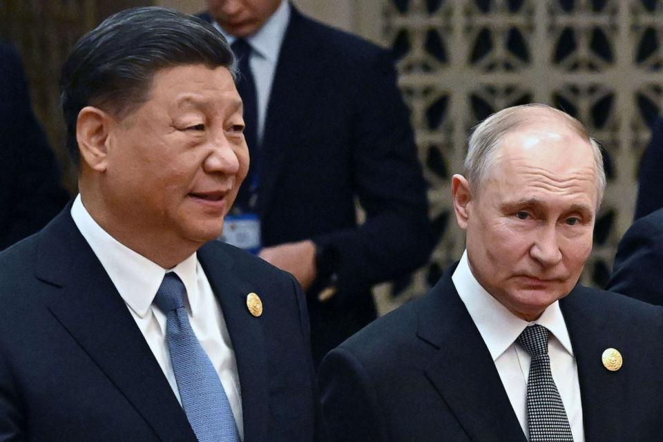 PHOTO: China's President Xi Jinping and Russia's President Vladimir Putin head to a group photo session during the third Belt and Road Forum for International Cooperation at the Great Hall of the People in Beijing on Oct. 18, 2023. (Grigory Sysoyev/POOL/AFP via Getty Images)