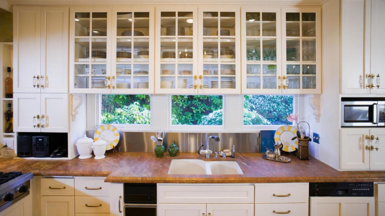 A kitchen with white cabinets