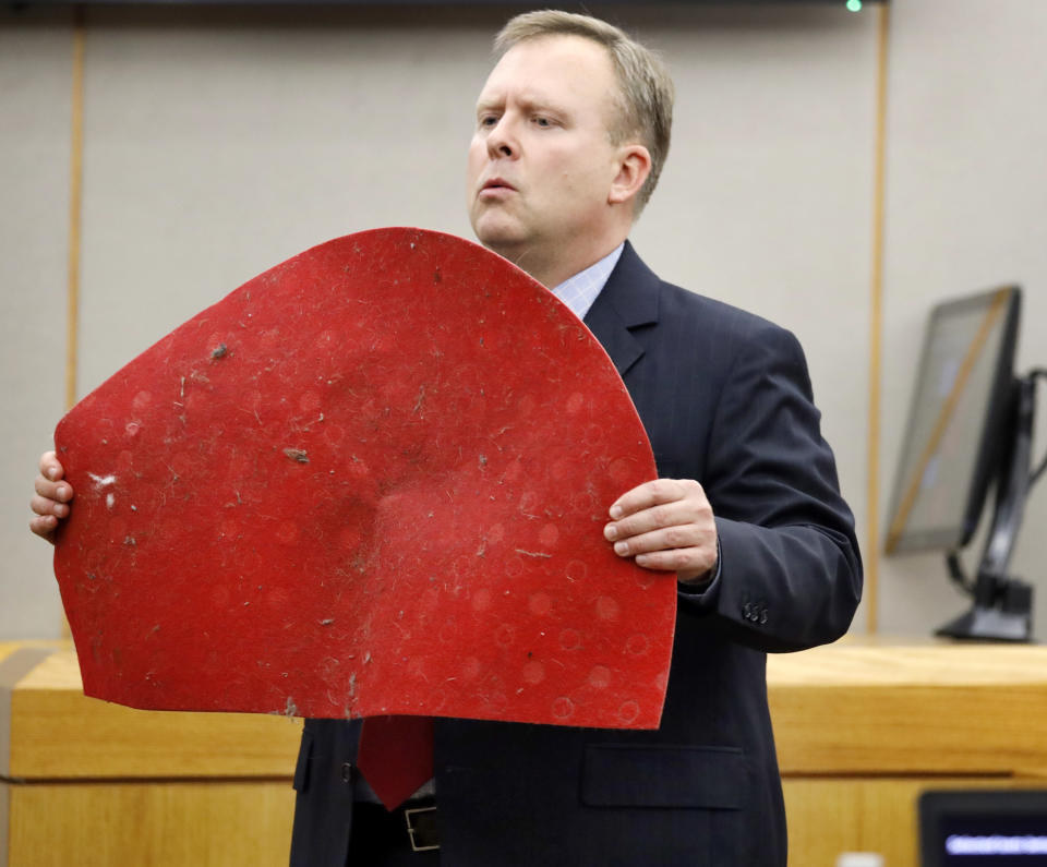 Assistant District Attorney Jason Hermus shows Botham Jean's doormat to the jury during his opening statement before the jury during former Dallas police Officer Amber Guyger''s trial in Dallas, Monday, Sept. 23, 2019. Guyger is accused of shooting Jean, her black neighbor in his Dallas apartment.(Tom Fox/The Dallas Morning News via AP, Pool)
