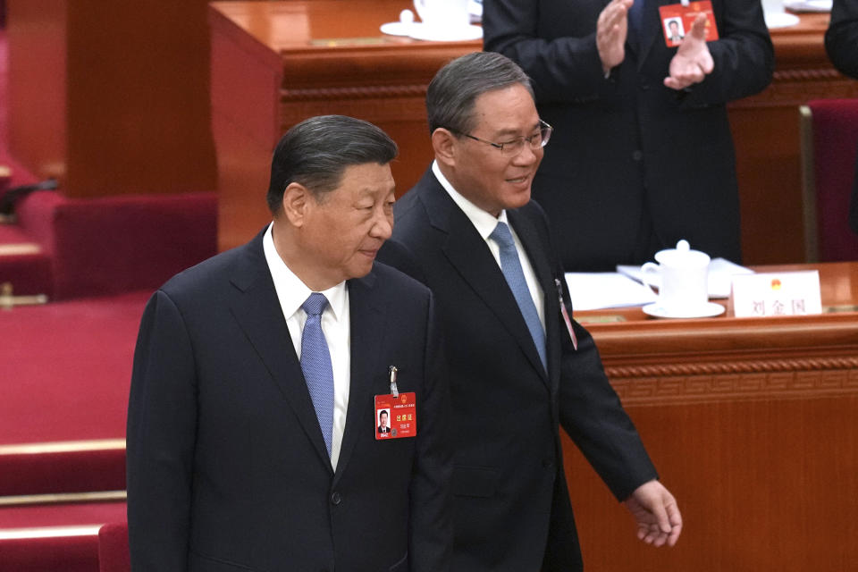 Chinese President Xi Jinping, left, and Chinese Premier Li Qianga arrive for the second plenary session meeting of the National People's Congress (NPC) in the Great Hall of the People in Beijing, China, Friday, March 8, 2024. (AP Photo/Tatan Syuflana)