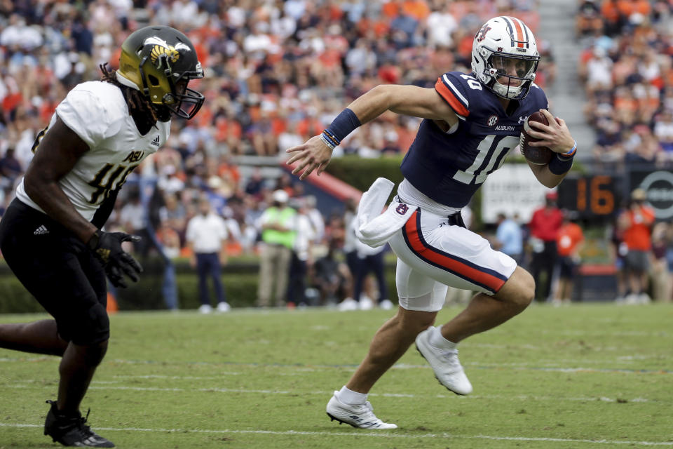 Auburn quarterback Bo Nix (10) carries the ball as Alabama State linebacker Jake Howard (46) pursues during the first half of an NCAA football game Saturday, Sept. 11, 2021, in Auburn, Ala. (AP Photo/Butch Dill)