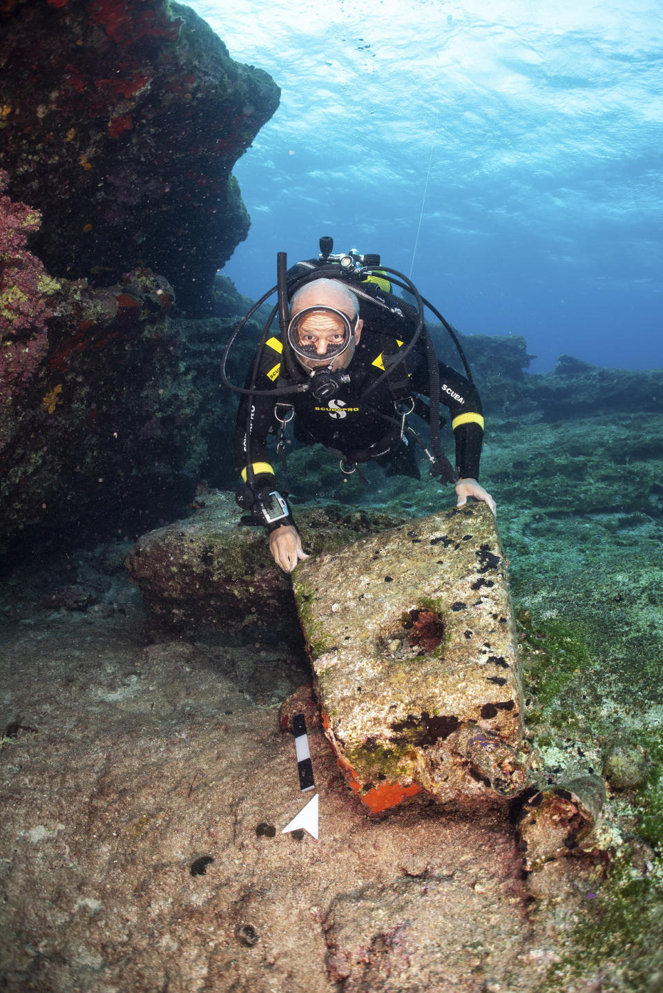 In this undated photo provide by the Greek Culture Ministry on Monday, Nov. 4, 2019, an archeologist takes part in an underwater excavation at the small Aegean island of Kasos, Greece. Greece's Culture Ministry says three shipwrecks from ancient and mediaeval times and large sections of their cargoes have been discovered off the island of Kasos. (Frode Kvalo/Greek Culture Ministry via AP)