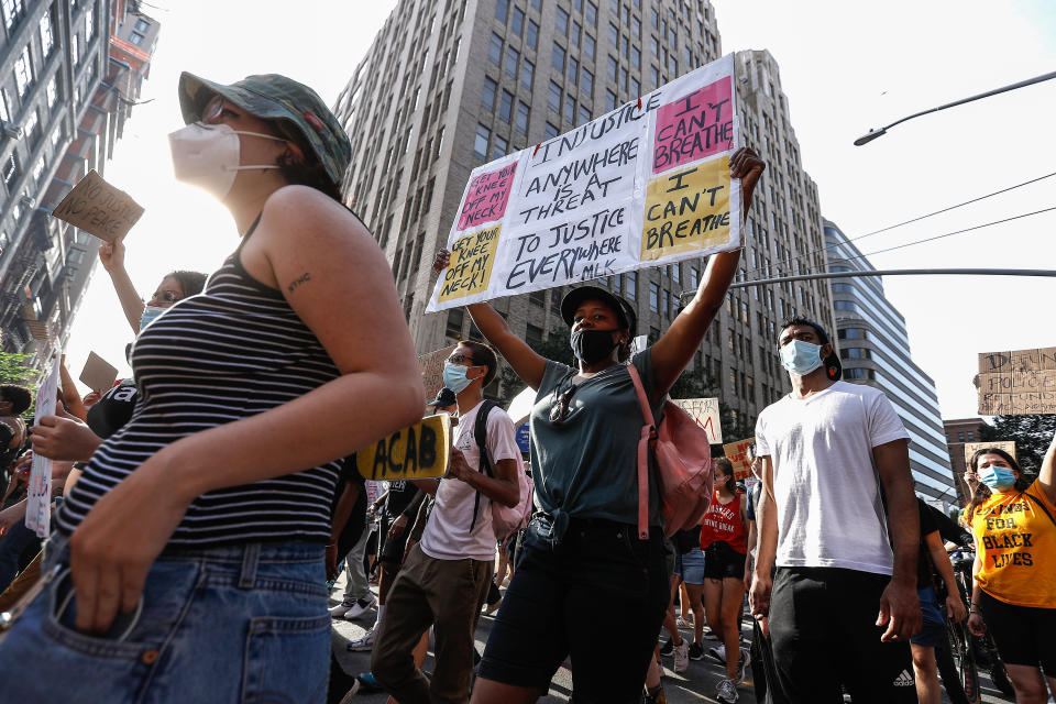 NEW YORK, UNITED STATES - 2020/06/15: Demonstrators hold placards as they march through the streets during the protest. Protests continue against police brutality and racial injustice in New York City. (Photo by John Lamparski/SOPA Images/LightRocket via Getty Images)