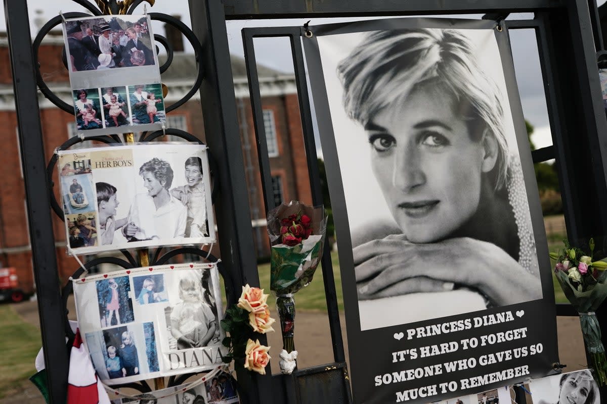 Tributes are left on the gates outside Kensington Palace, London (Aaron Chown/PA) (PA Wire)