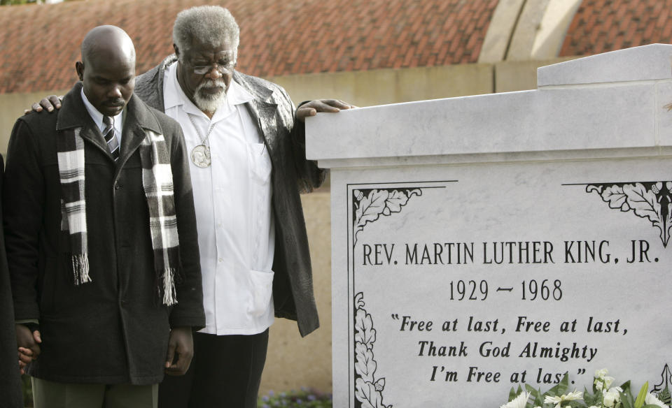 FILE - In this Jan. 12, 2007, file photo, the Rev. James Orange, right, and Obang Metho pray after helping to lay a wreath at the tombs of the Rev. Martin Luther King Jr. and his wife Coretta Scott King at the King Center for non-violent Social Change in Atlanta. When students began skipping school to join the marches, authorities arrested Orange on Feb. 18, 1965, for contributing to the delinquency of minors. (AP Photo/John Bazemore, File)