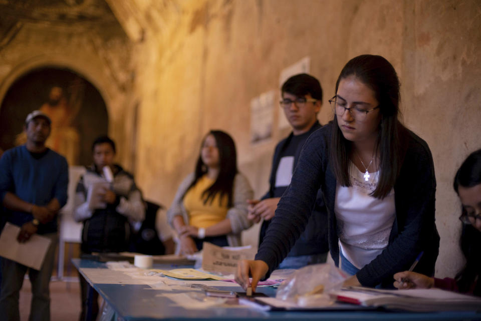 Election officials start counting votes after polling stations closed during general elections in Antigua, Guatemala, Sunday, June 16, 2019. Voters are choosing between 19 candidates for a four-year presidential term that begins Jan. 2020. The winner needs an absolute majority, making an August runoff between the two top vote-getters likely. (AP Photo/Santiago Billy)