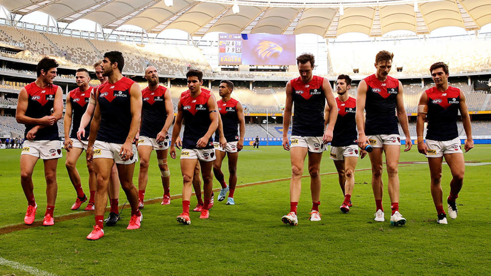 Pictured here, the Melbourne Demons walk off after their round one loss to West Coast.