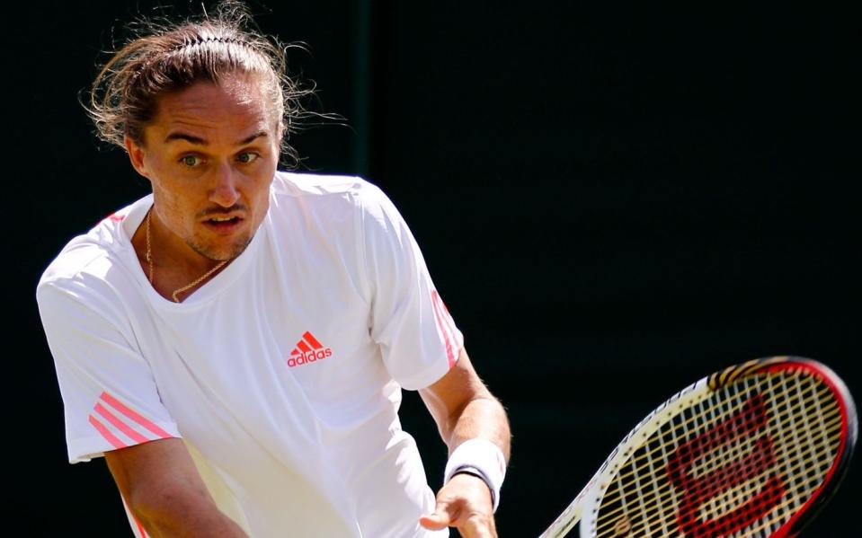 Alexandr Dolgopolov of Ukraine in action during his Gentlemen&#39;s Singles first round match against Alex Bogomolov Jr. of Russia on day two of the Wimbledon Lawn Tennis Championships